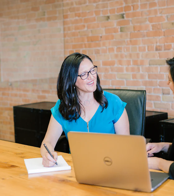Professional reviewing acquisition data on a laptop.