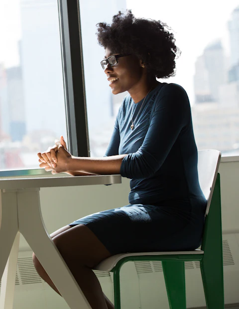 Professional working at a laptop by the window.